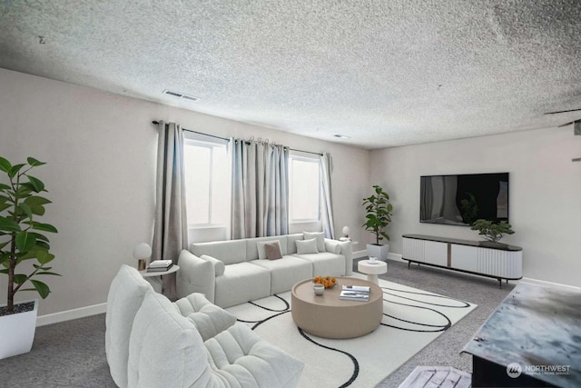 carpeted living room featuring a textured ceiling