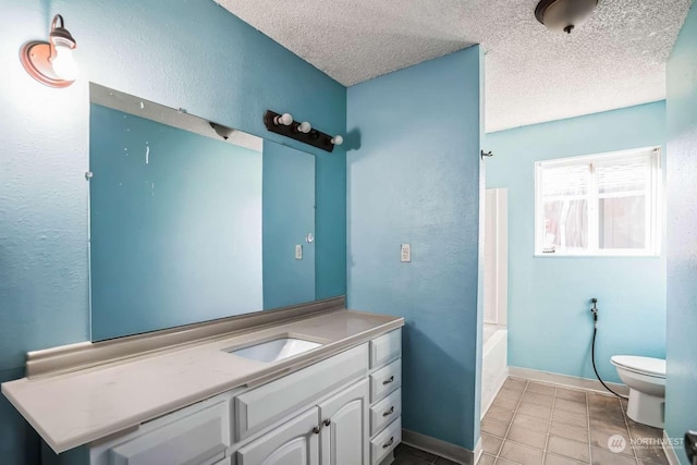 full bathroom with washtub / shower combination, tile patterned flooring, vanity, a textured ceiling, and toilet