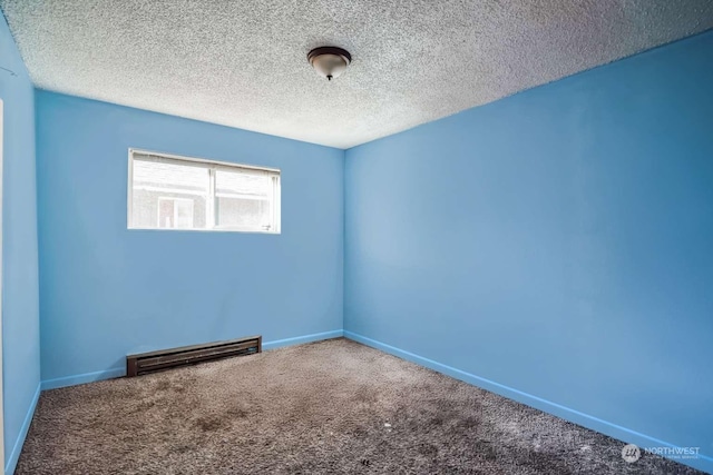 spare room featuring carpet and a textured ceiling