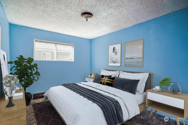 bedroom featuring dark wood-type flooring and a textured ceiling