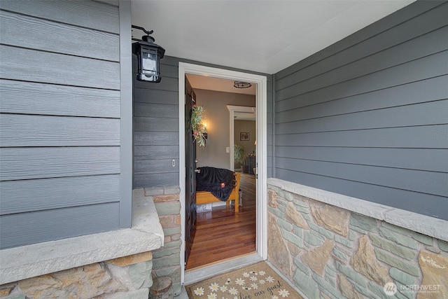 doorway to property with stone siding