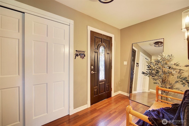 foyer with wood finished floors and baseboards