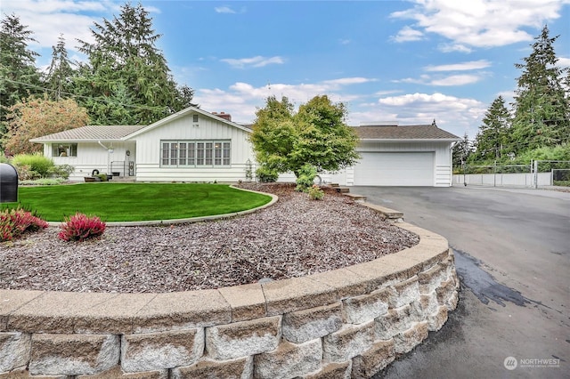 ranch-style home featuring a garage and a front lawn