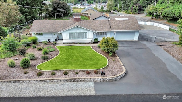 view of front of home with a garage and a front yard