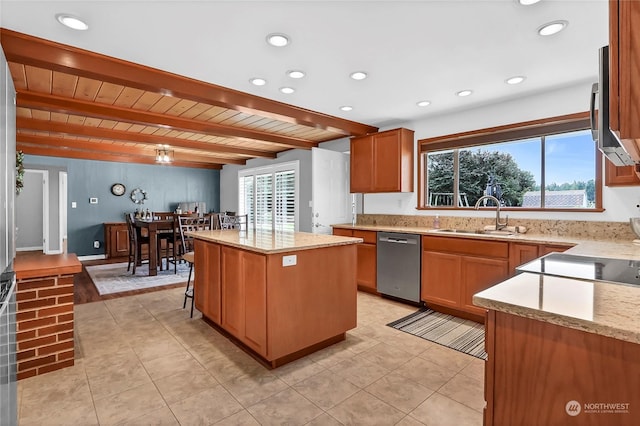 kitchen with stainless steel appliances, a kitchen island, sink, and light stone counters