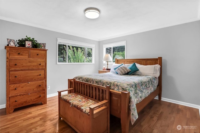 bedroom with wood-type flooring and crown molding