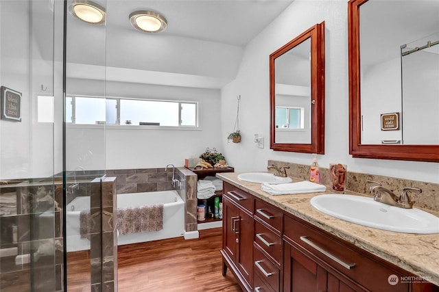 bathroom featuring vanity, hardwood / wood-style floors, and separate shower and tub