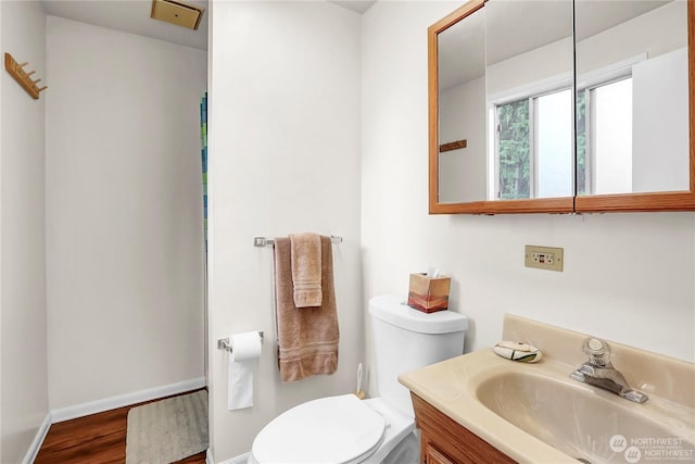 bathroom with vanity, hardwood / wood-style flooring, and toilet