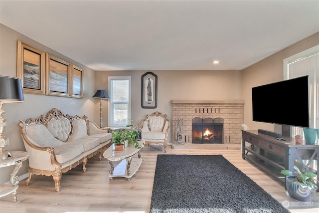 living room with a fireplace and light hardwood / wood-style flooring