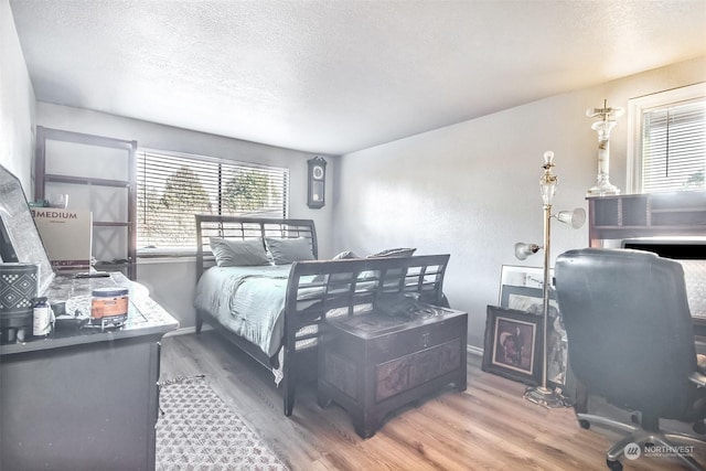 bedroom featuring hardwood / wood-style floors and a textured ceiling