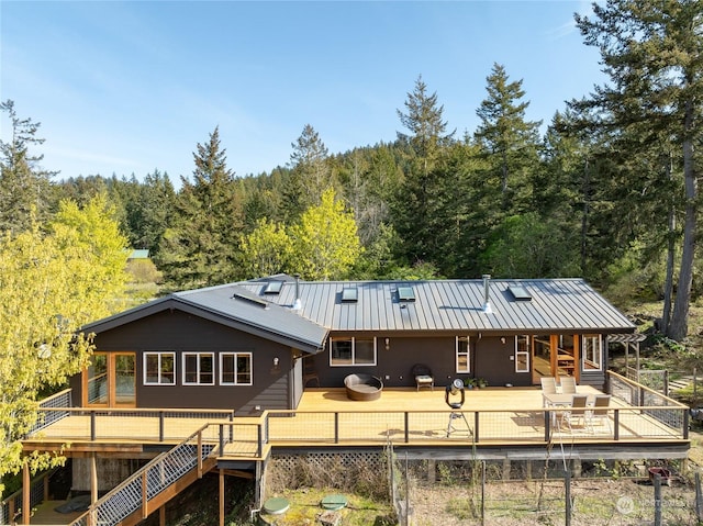 back of house featuring a deck