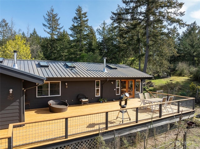 back of property featuring a wooden deck