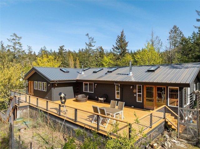 rear view of property with a wooden deck