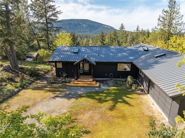 view of front of home featuring a mountain view and a front lawn