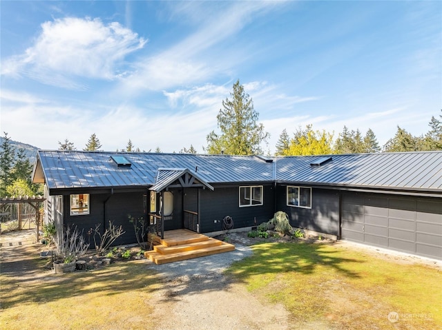 ranch-style house featuring a garage and a front lawn