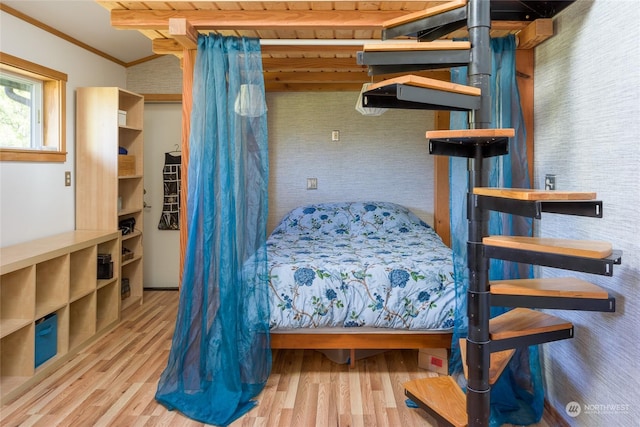 bedroom featuring crown molding and light wood-type flooring