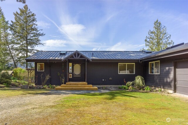 single story home with a garage and a front lawn