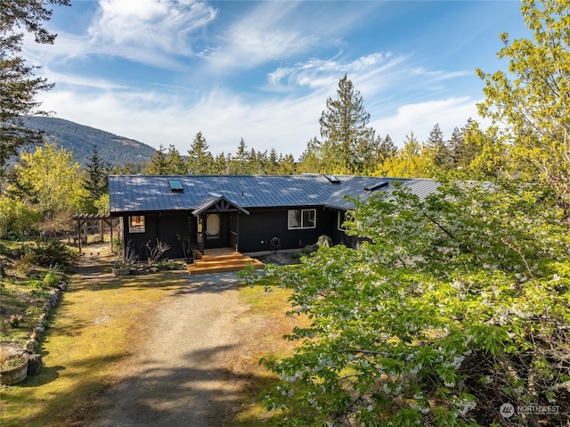 ranch-style house with a mountain view and a pergola