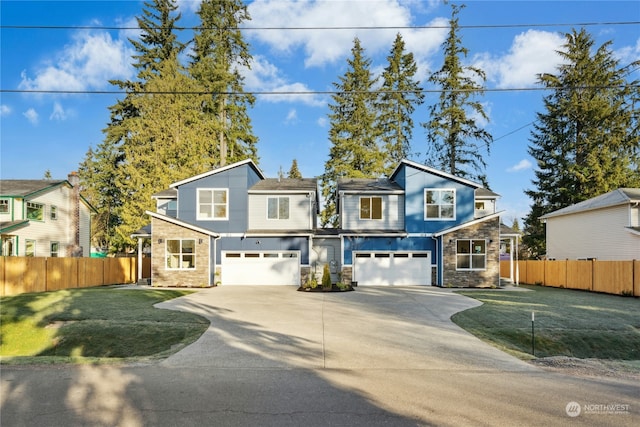 view of front property featuring a garage and a front yard