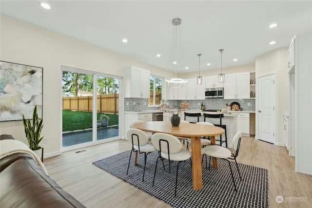 dining space featuring light wood-type flooring