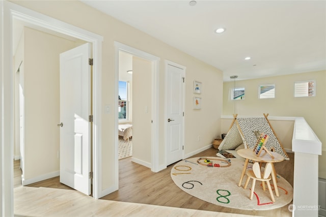 playroom with light hardwood / wood-style floors