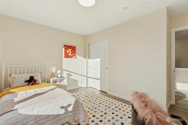 bedroom with hardwood / wood-style flooring