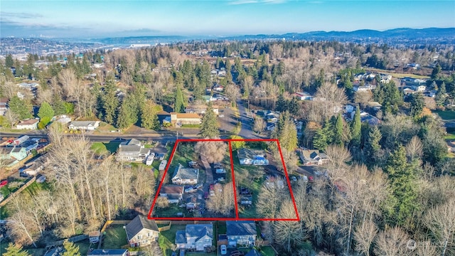 aerial view with a mountain view and a wooded view