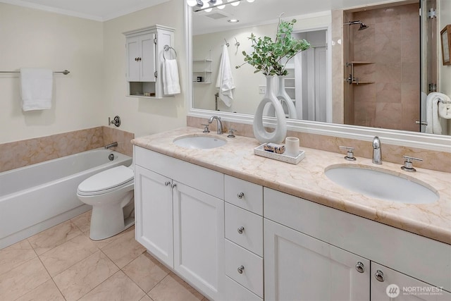 bathroom featuring double vanity, marble finish floor, ornamental molding, and a sink