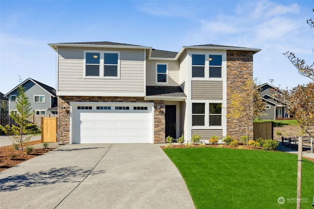 view of front of property featuring a garage and a front yard