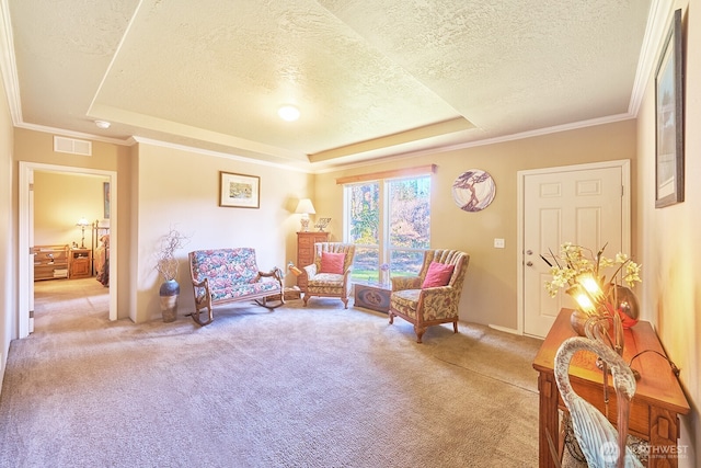 living area featuring crown molding, carpet flooring, a tray ceiling, and a textured ceiling