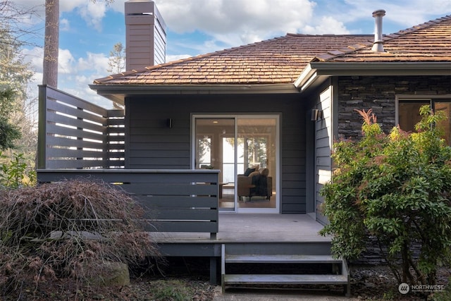 rear view of house featuring a wooden deck