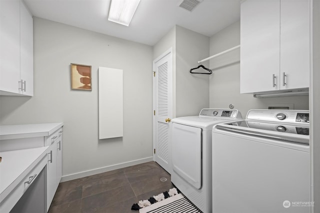 laundry area featuring cabinets and washer and clothes dryer