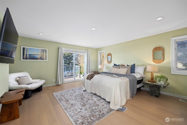 bedroom with access to outside and light hardwood / wood-style floors