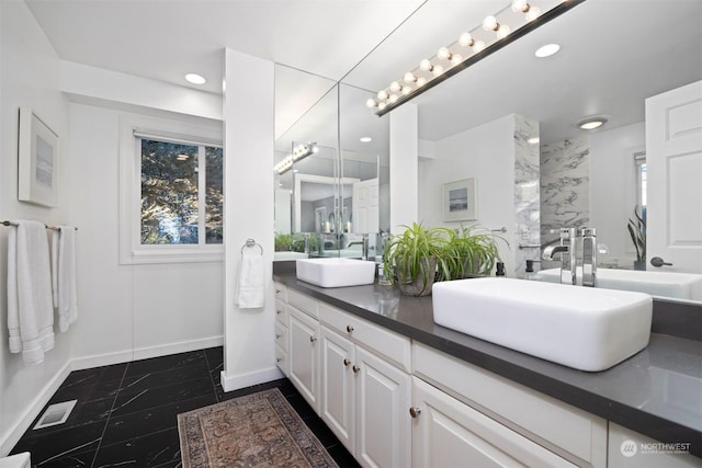 bathroom with vanity, a wealth of natural light, and walk in shower