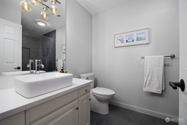 bathroom featuring a shower with door, vanity, and toilet