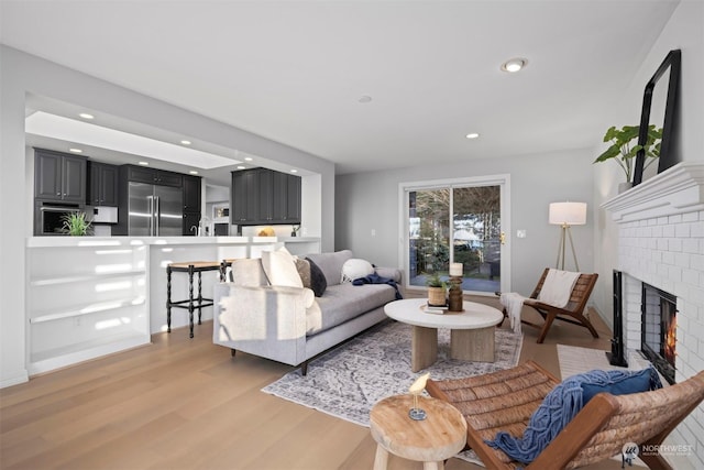 living room with a fireplace and light hardwood / wood-style floors