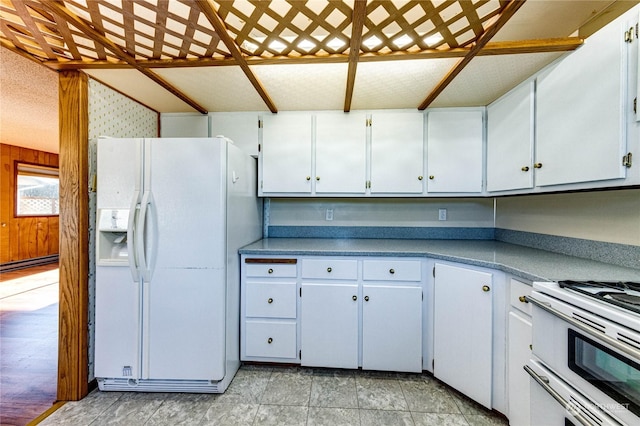 kitchen with white cabinetry and white appliances