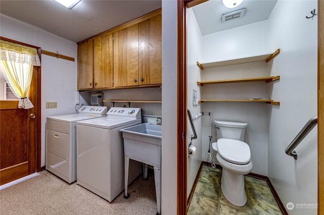 laundry room featuring cabinets and washing machine and clothes dryer