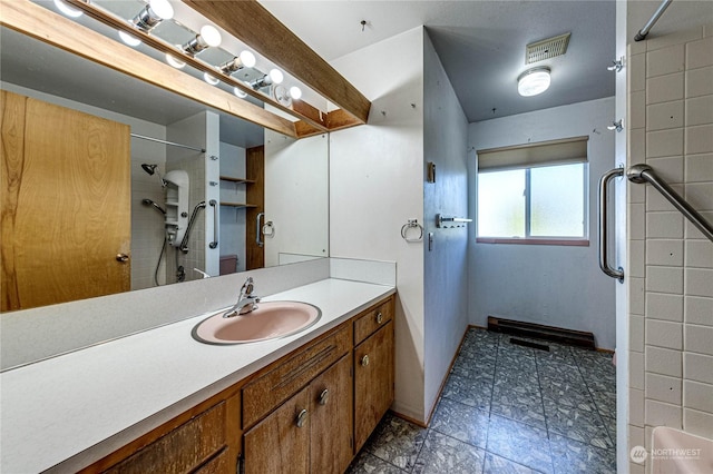 bathroom featuring vanity and a tile shower