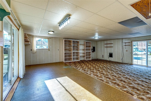 basement with a paneled ceiling