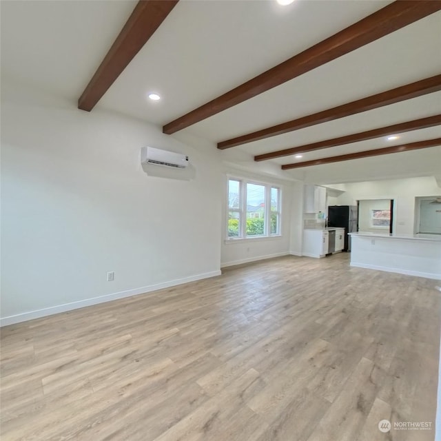 unfurnished living room featuring beam ceiling, light hardwood / wood-style flooring, and a wall unit AC