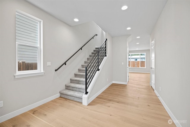 stairway with hardwood / wood-style floors