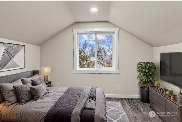 bedroom with vaulted ceiling and carpet flooring