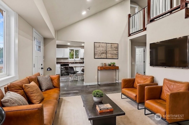 living room featuring high vaulted ceiling and light wood-type flooring