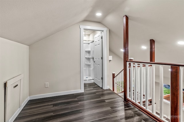 bonus room with vaulted ceiling, dark wood-type flooring, and a textured ceiling