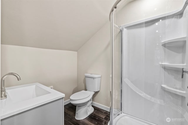 bathroom with lofted ceiling, toilet, a shower with shower door, vanity, and hardwood / wood-style floors