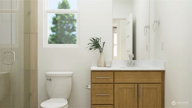 bathroom with vanity, toilet, and a shower with door