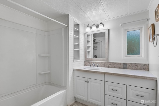 bathroom with vanity, crown molding, shower / washtub combination, and a textured ceiling