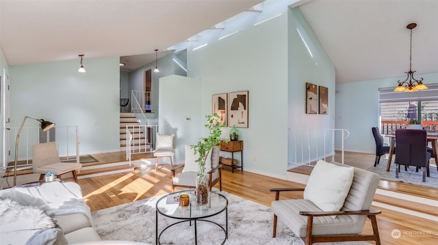 living room featuring high vaulted ceiling and light wood-type flooring