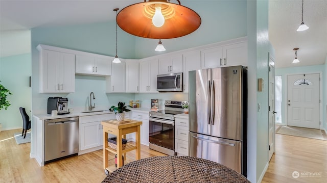 kitchen featuring stainless steel appliances, sink, and white cabinets